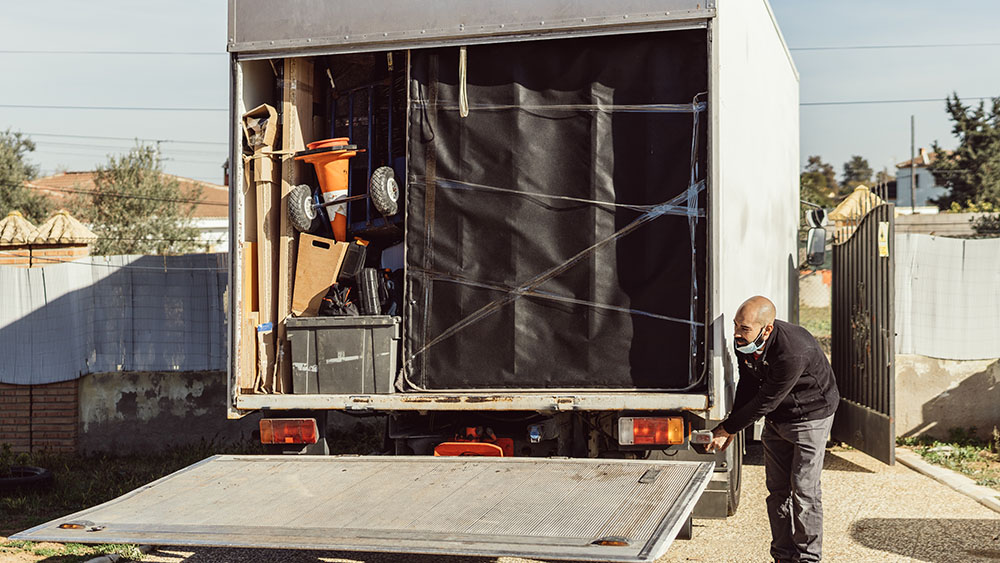 man-unloading-moving-truck-in-residential-neighbor-2026-03-09-08-59-01-utc